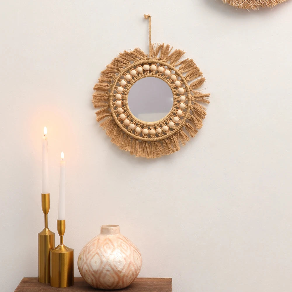 Boho fringe circle wall mirror with natural fiber frame.