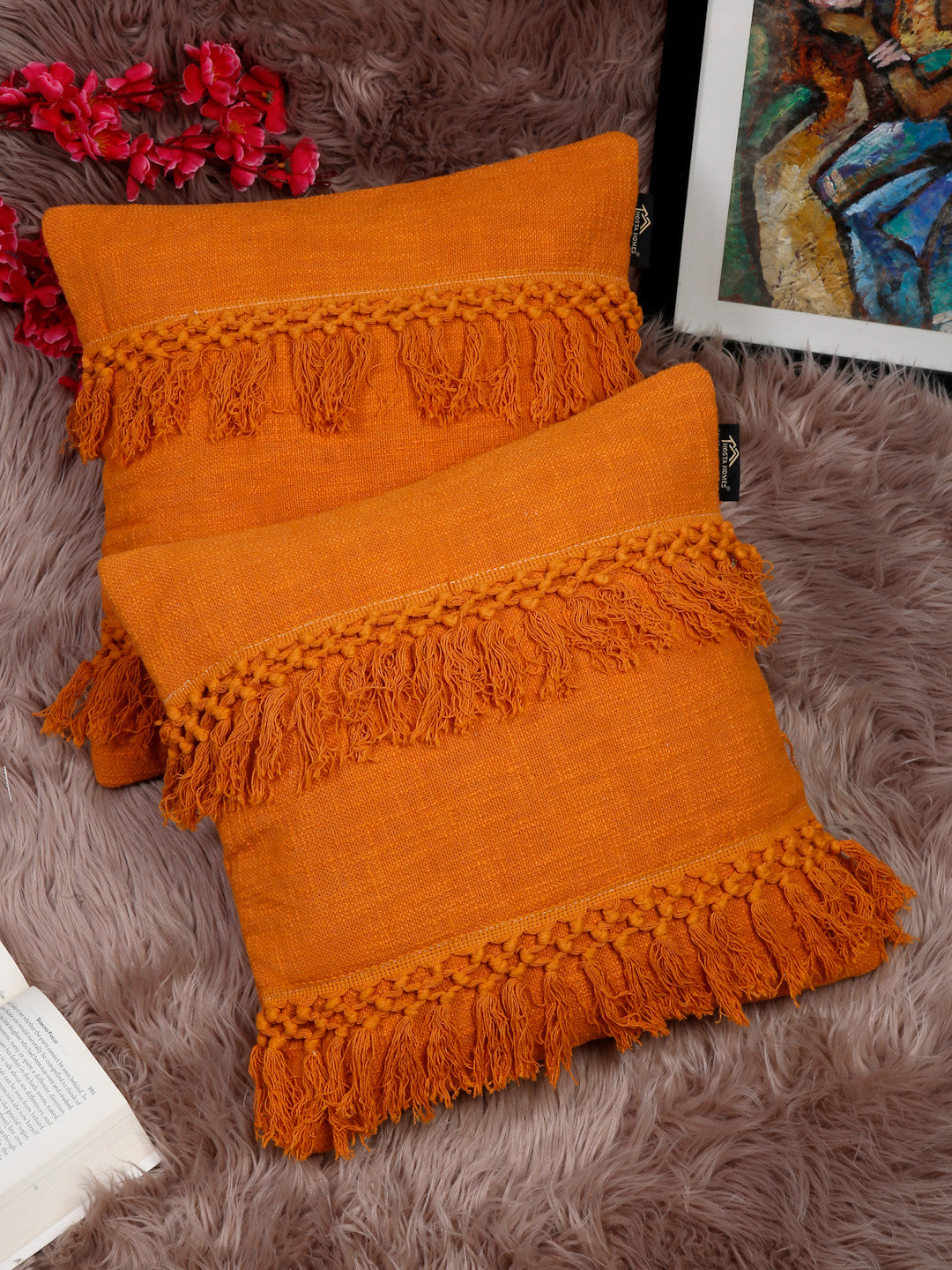 Orange self-design pure cotton pillow covers with fringe pattern.