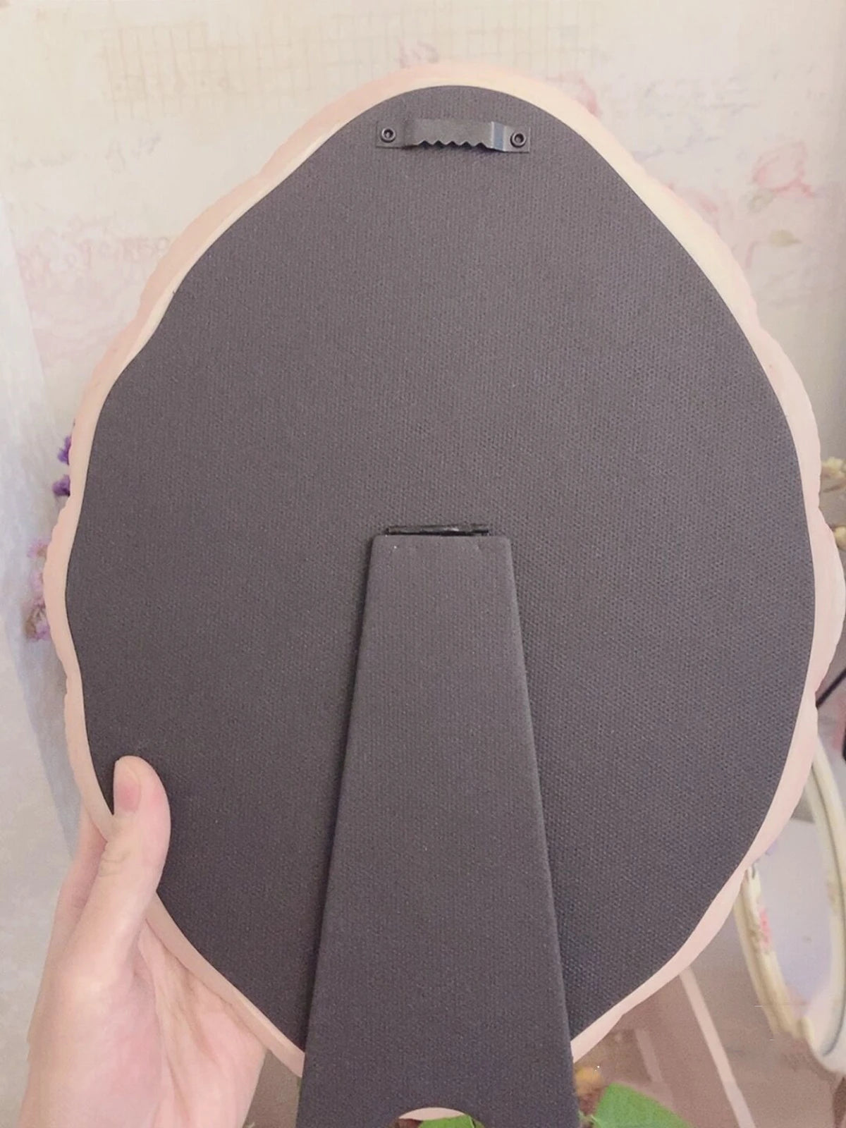 Vintage pink floral oval mirror for bedroom décor.