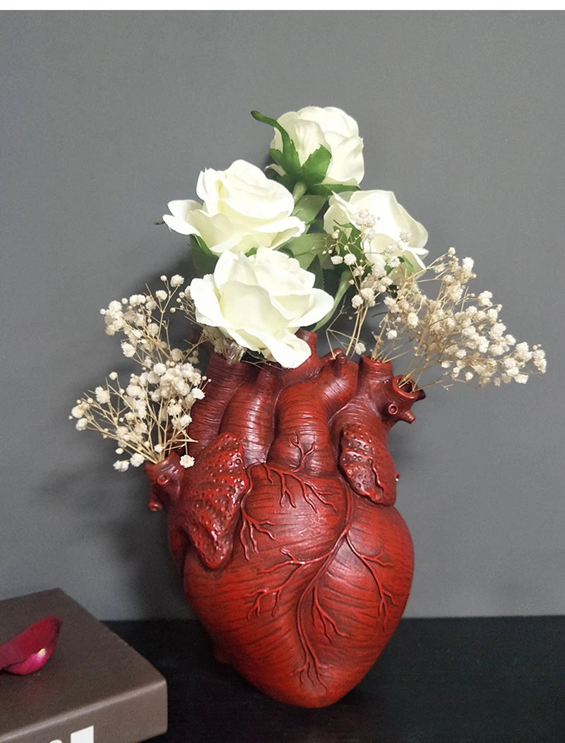 Creative large heart flower vase on wooden tabletop.