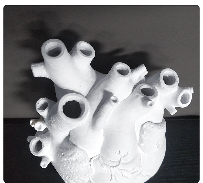 Modern resin flowerpot shaped like a human heart.
