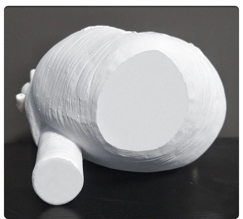 Elegant white heart-shaped resin sculpture with flowers.