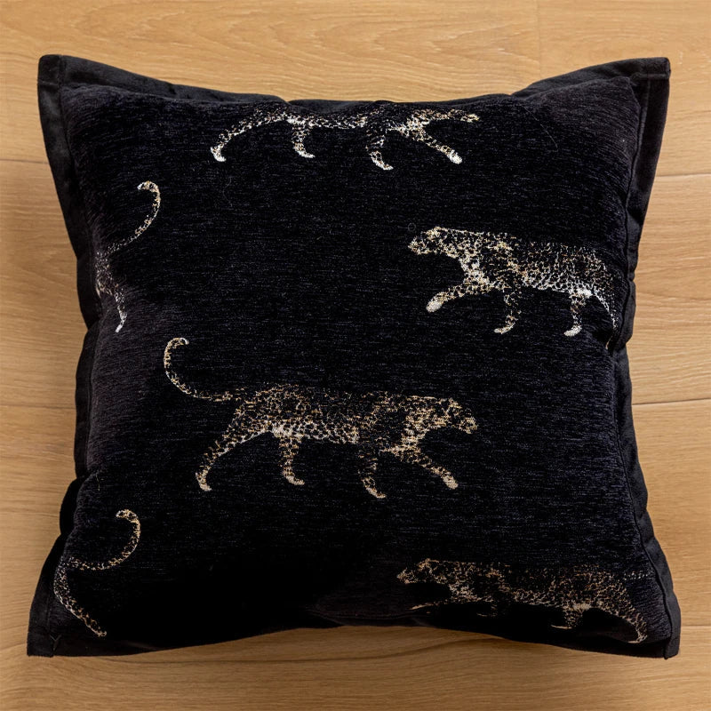 Black pillow with leopard embroidery design.