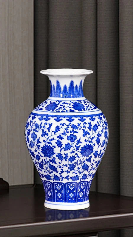 Antique-inspired blue porcelain vase with white background.