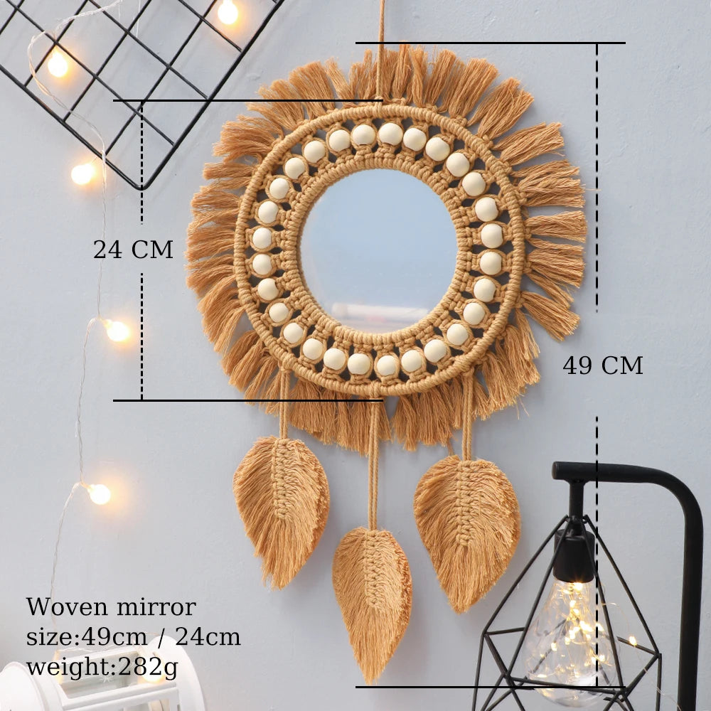 Round woven wall hanging mirror with fringe details.