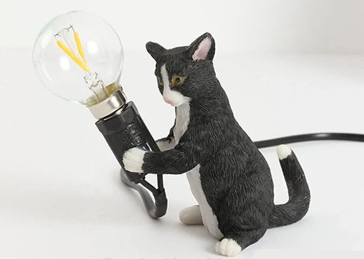 Durable resin and iron cat figurine table lamp.