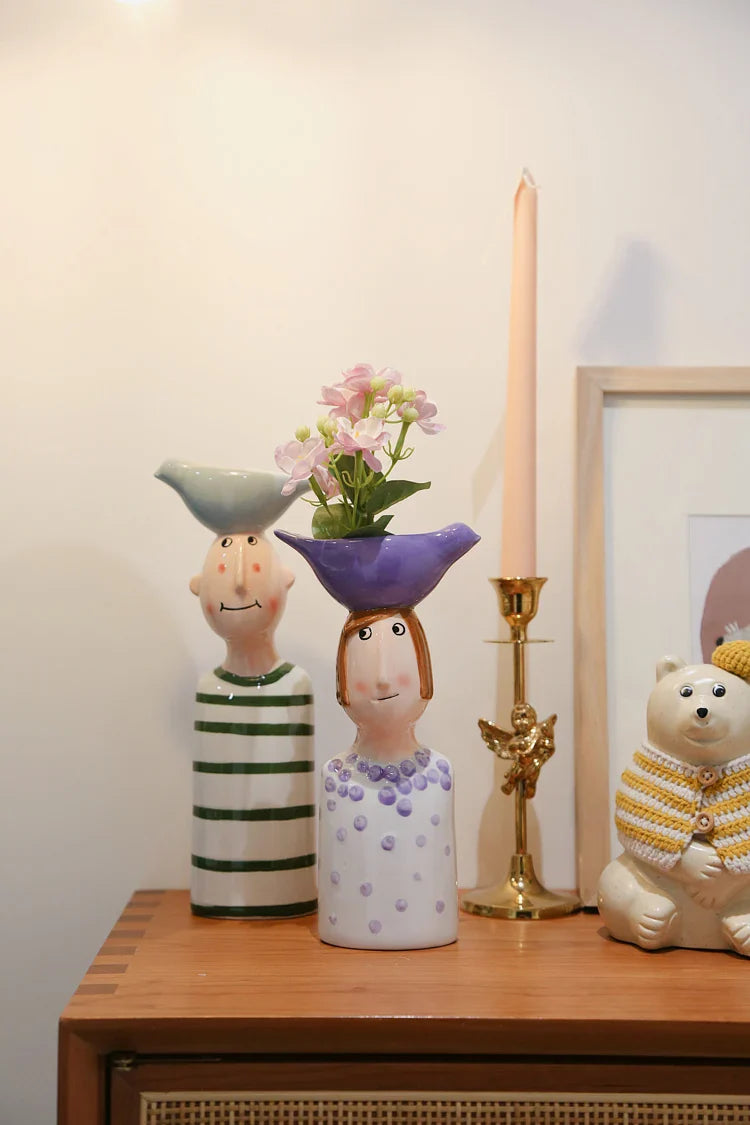 Artistic ceramic face vases for home decoration.