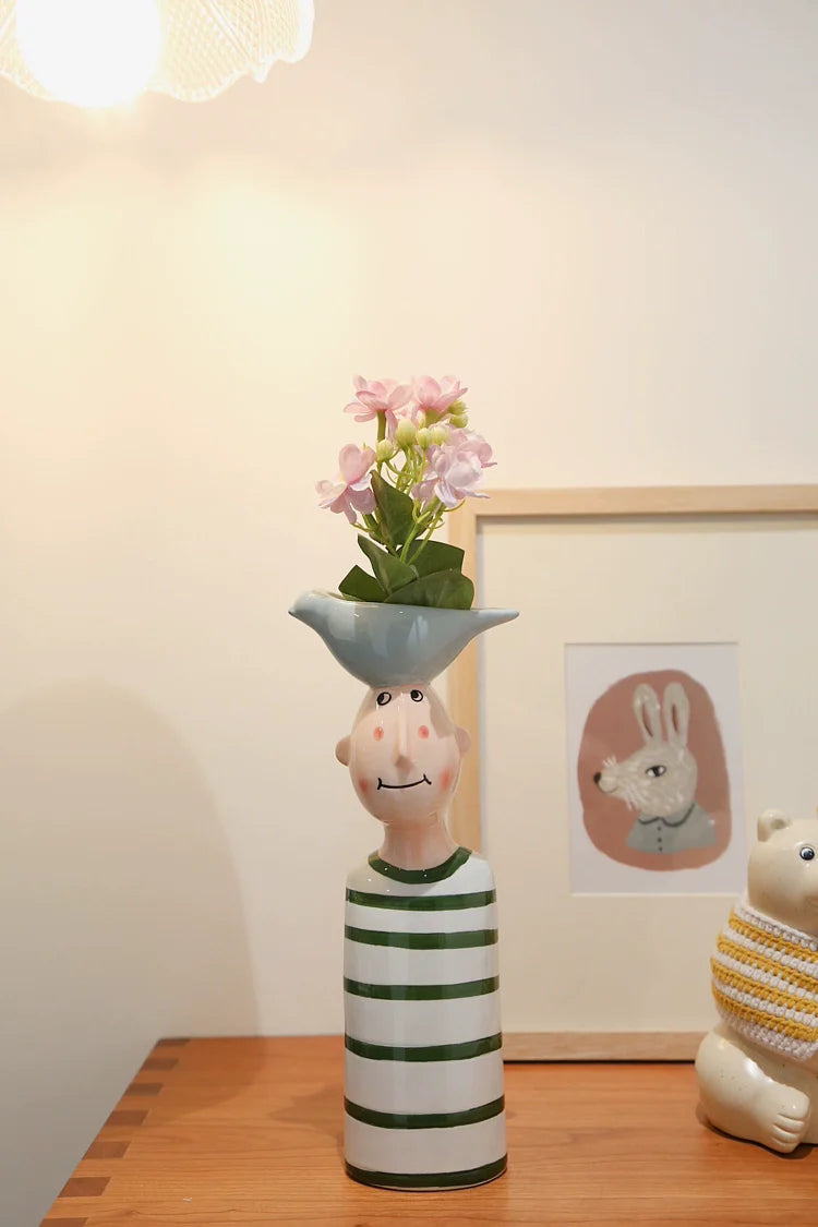 Playful ceramic face vases for interior decoration.