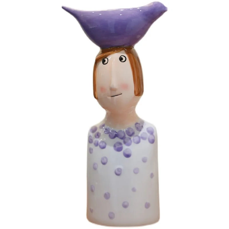 Decorative ceramic vases shaped like boy and girl figures.