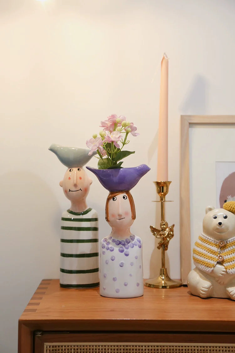 Creative tabletop couple vases for flower display.