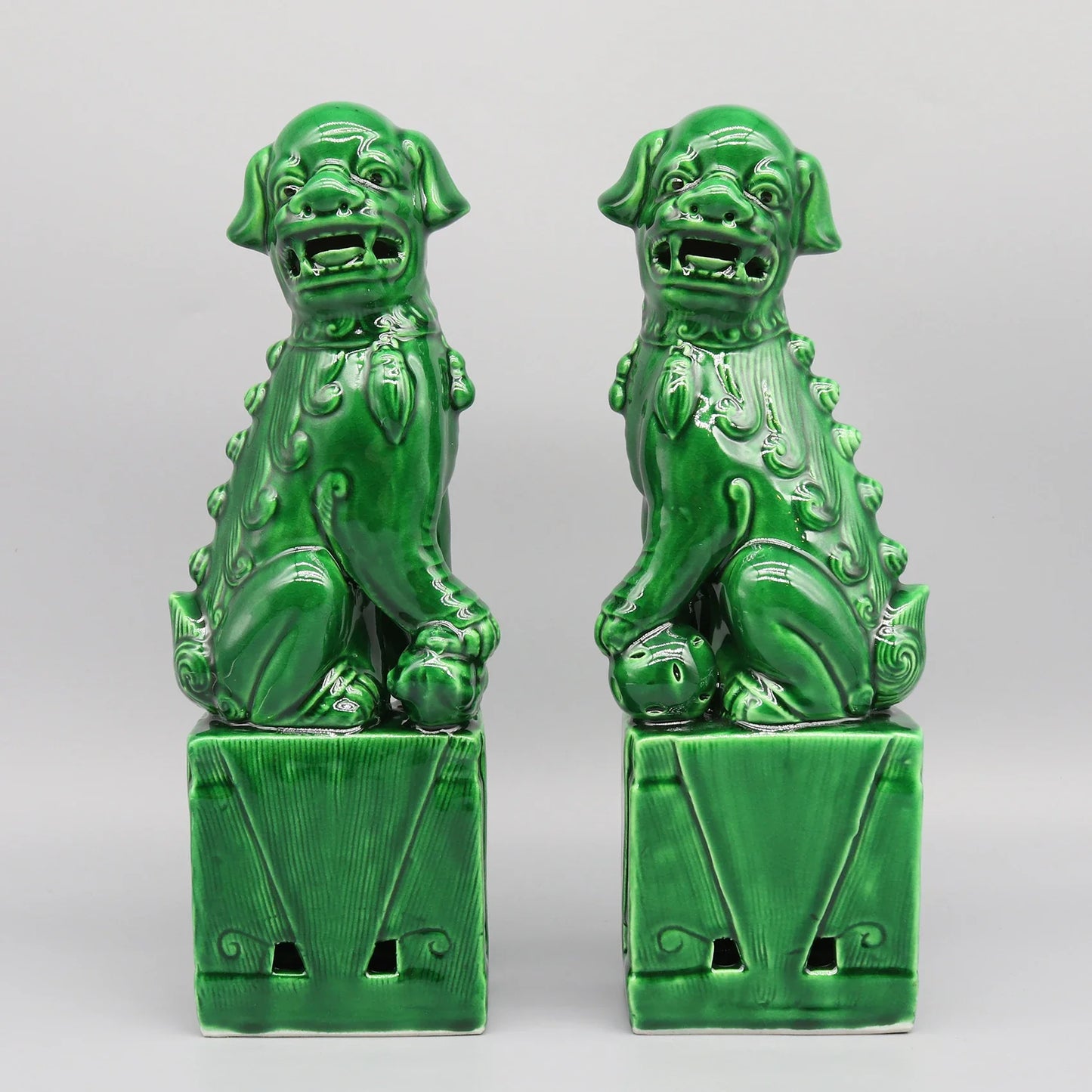 Glossy army green Foo Dogs ceramic sculptures.