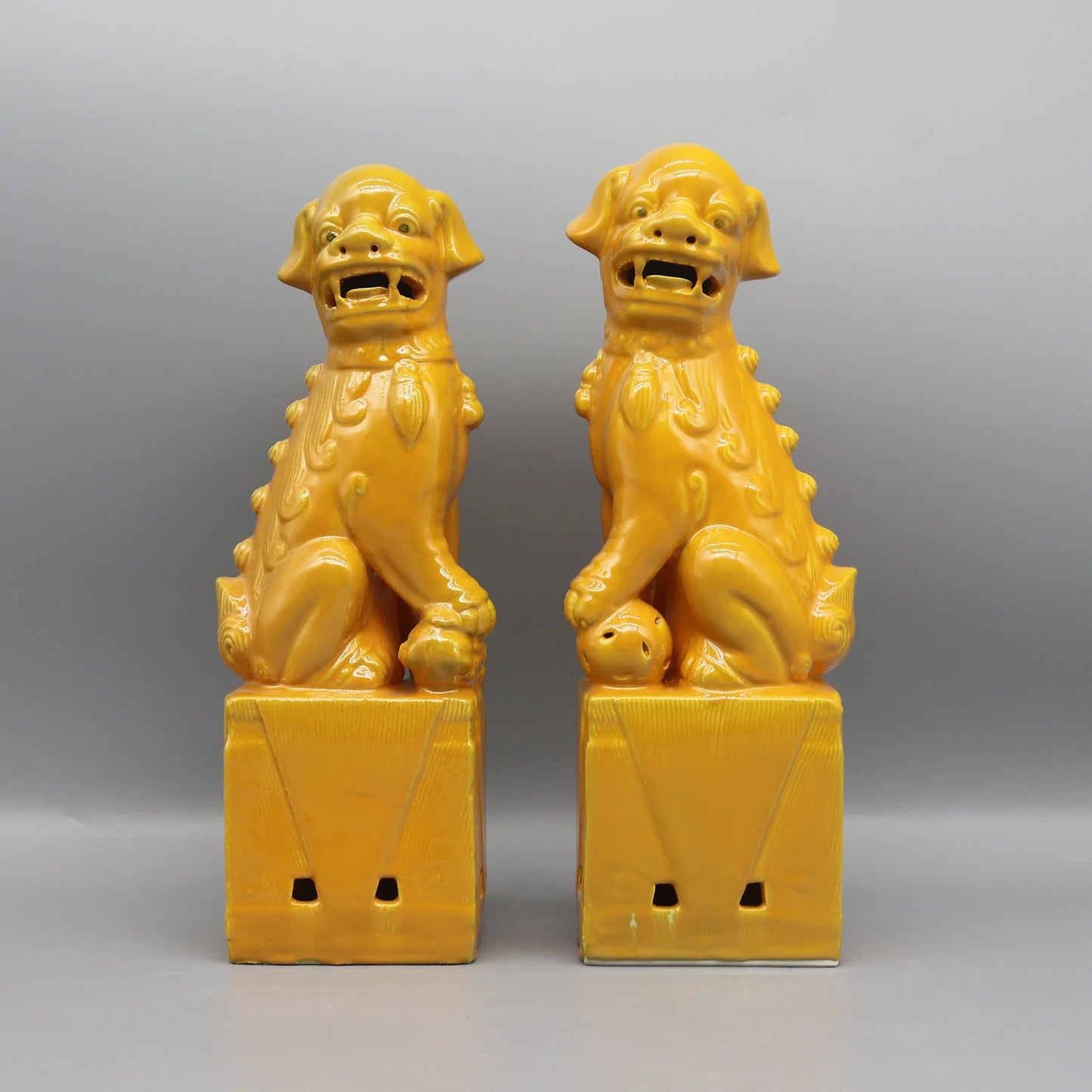 Antique-style yellow Foo Dogs ceramic guardian statues.