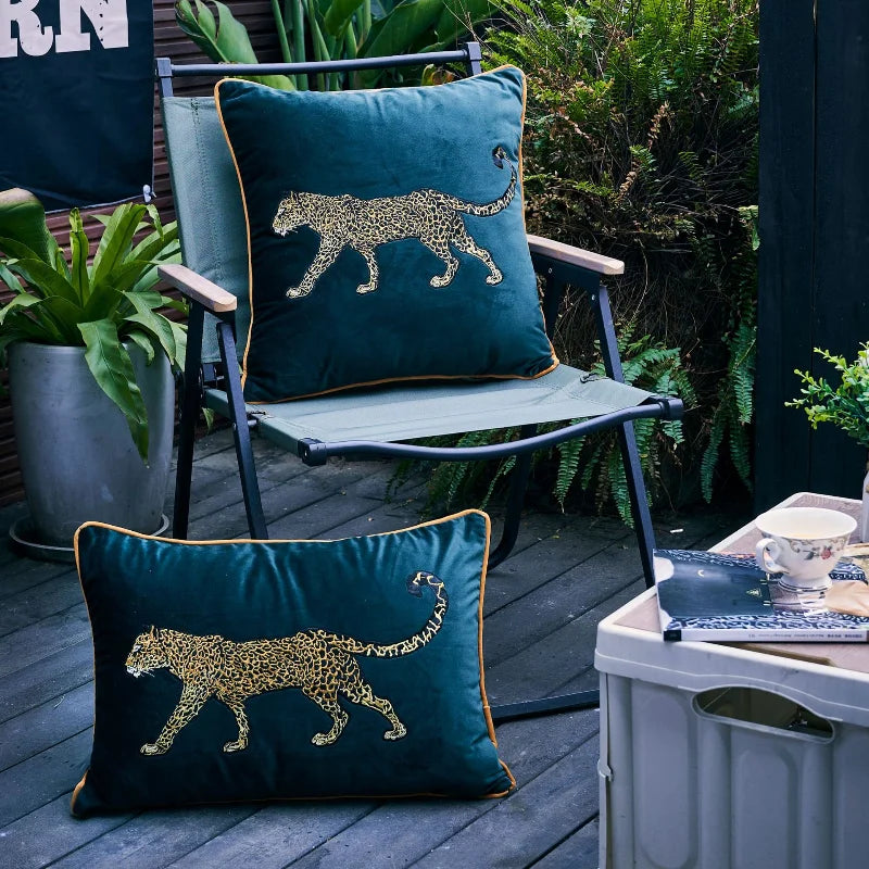 Green velvet pillow with gold leopard embroidery for living room décor.