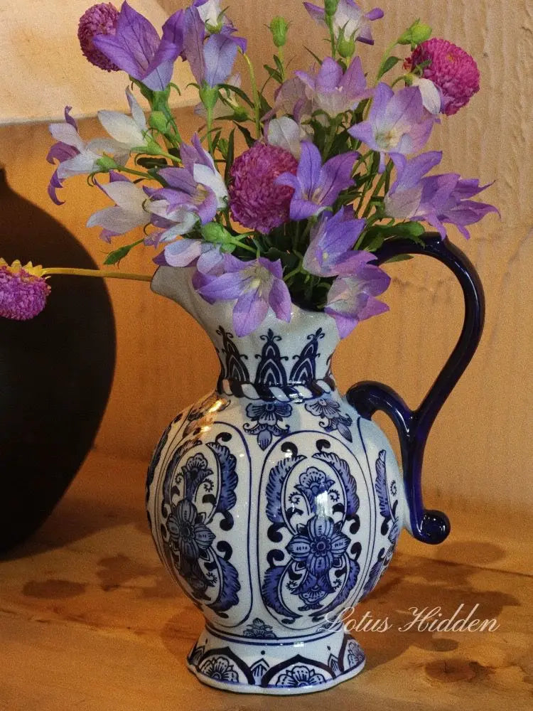 Antique ceramic vase with artistic hand-drawn designs.