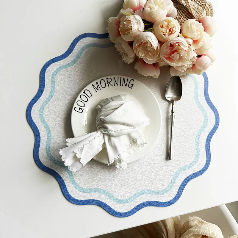 Blue wavy-edge waterproof table mat for modern dining décor.