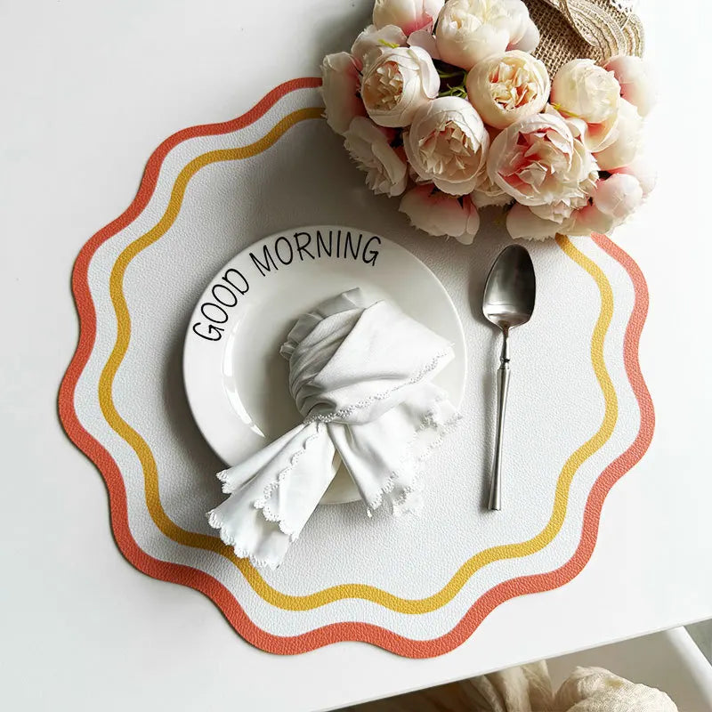 Orange floral stripe design placemat on white dining table.