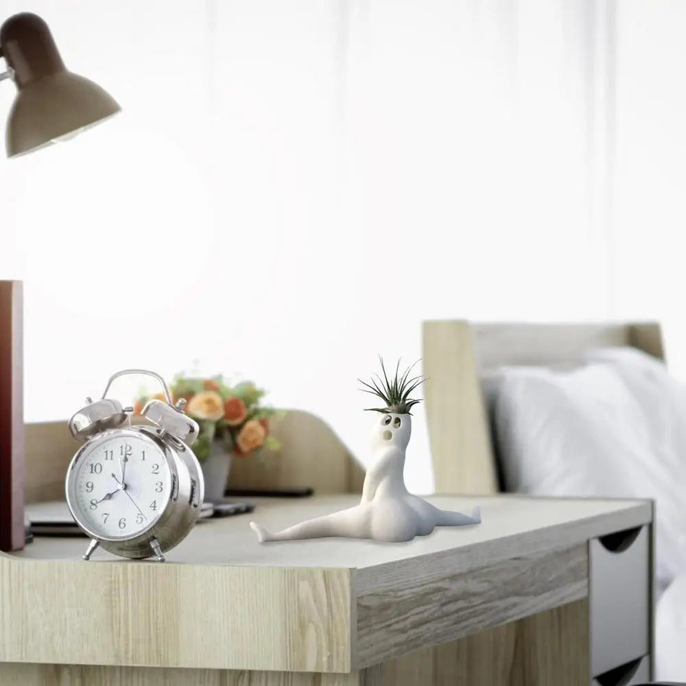 White ghost air plant holder with humorous design.