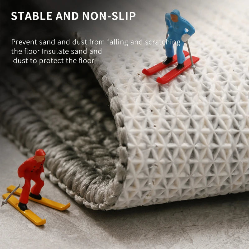 Absorbent kitchen rug in grey tones.