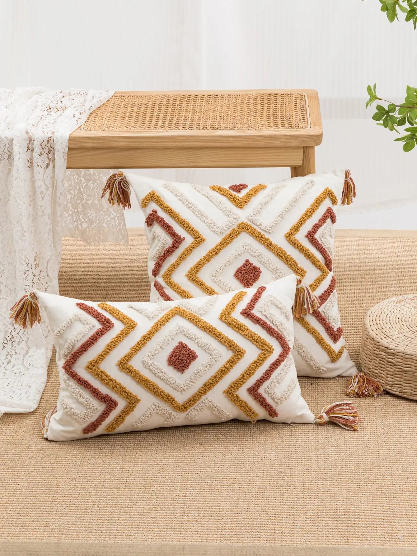 Polyester pillow cover with tasseled corners in geometric style.