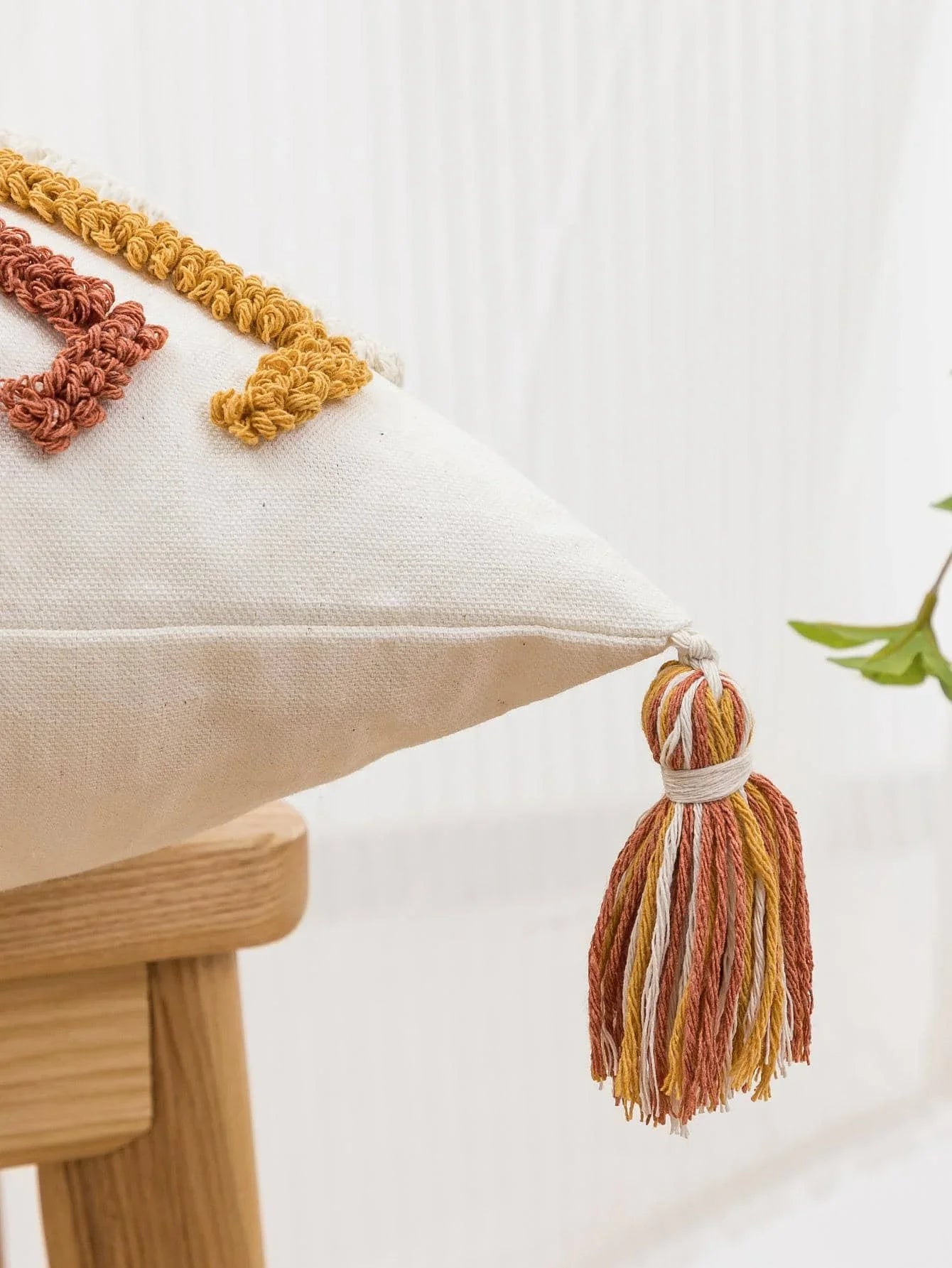 Rustic chic cushion case with tassels for lounge seating.
