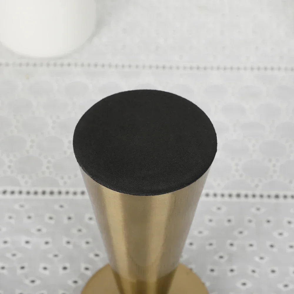 Metallic gold candle stand for living room decor.