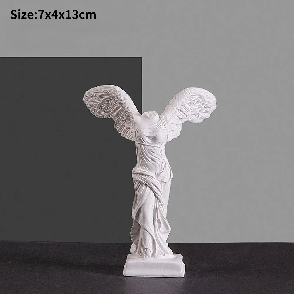 White decorative sculpture with flowing drapery design.