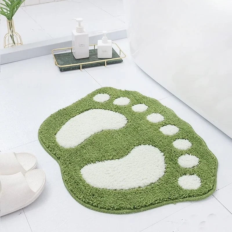 Green non-slip absorbent rug for bathroom and shower use.