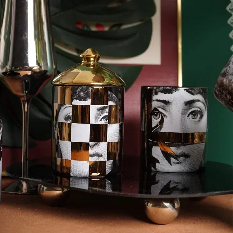 Decorative ceramic candle holder with golden lid.