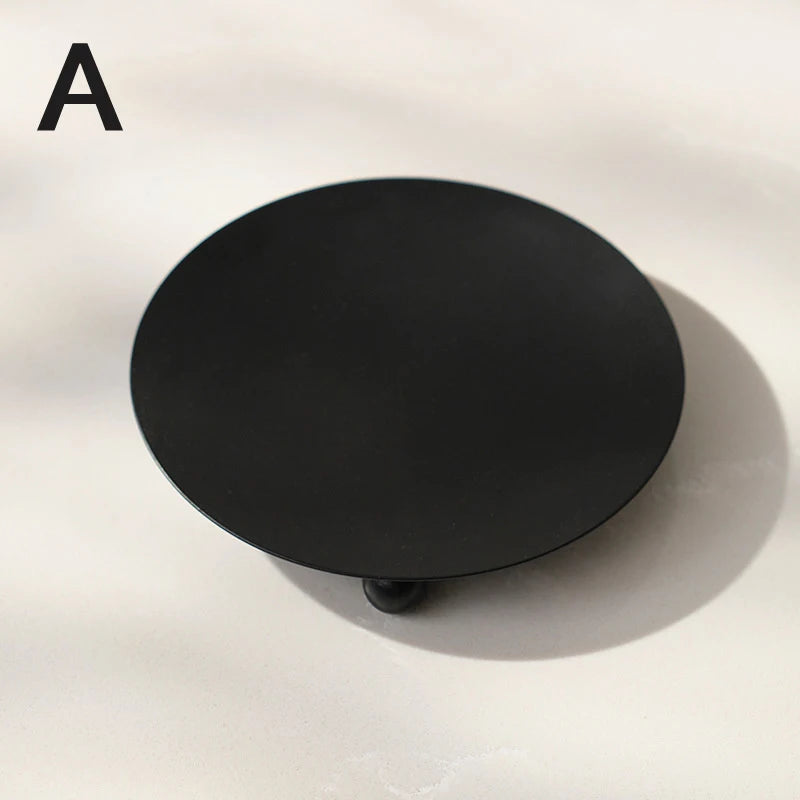 Black candle holder with iron base for bedroom décor.