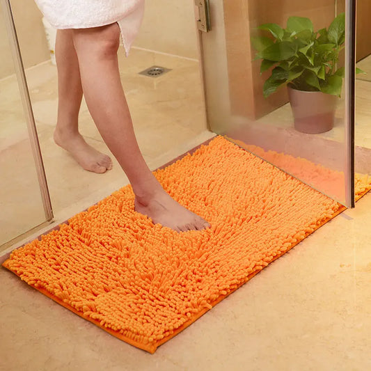 Orange memory foam bathroom rug with non-slip bottom.