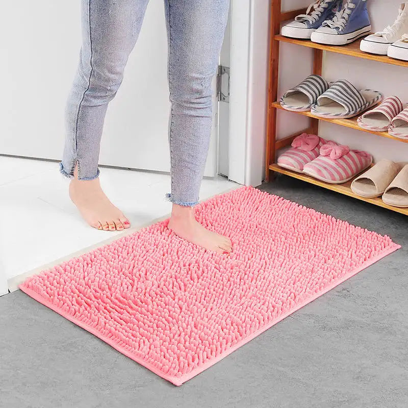 Pink memory foam bath rug with absorbent surface.
