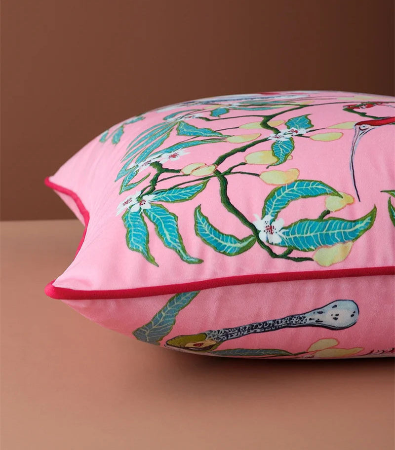 Modern luxury sofa pillow with tropical bird and foliage motif.