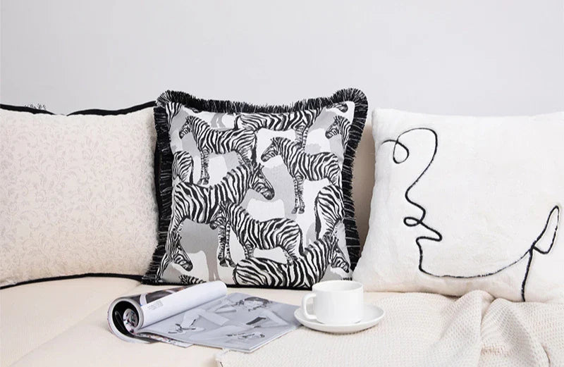 Black and white geometric cushion cover with zebra print design.