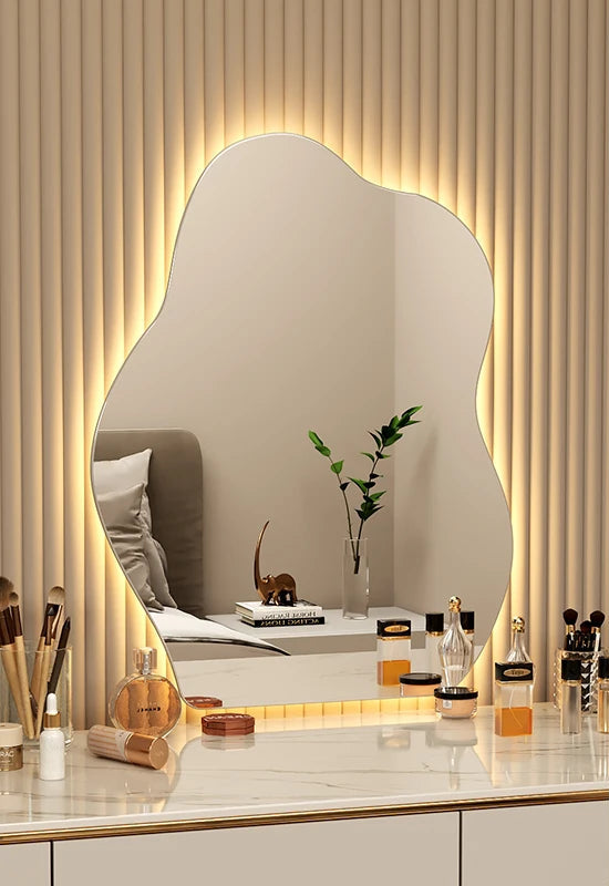 LED-lit artistic mirror with smooth fluid design.
