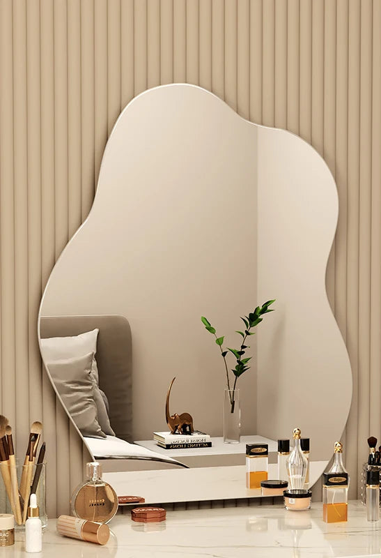 LED vanity mirror with curvy organic frame for bedroom wall.