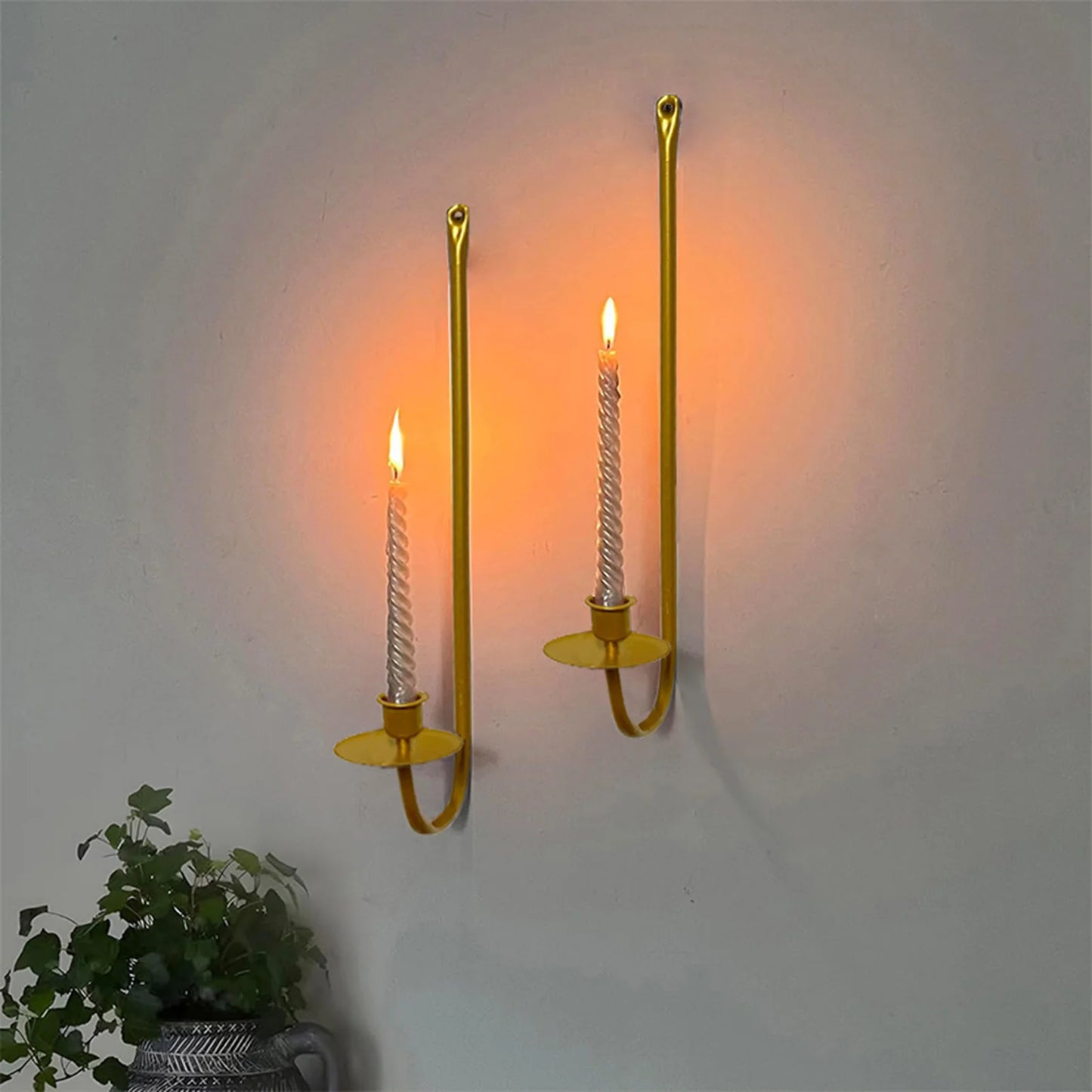 Minimalist gold candle sconce for festive and home decoration.