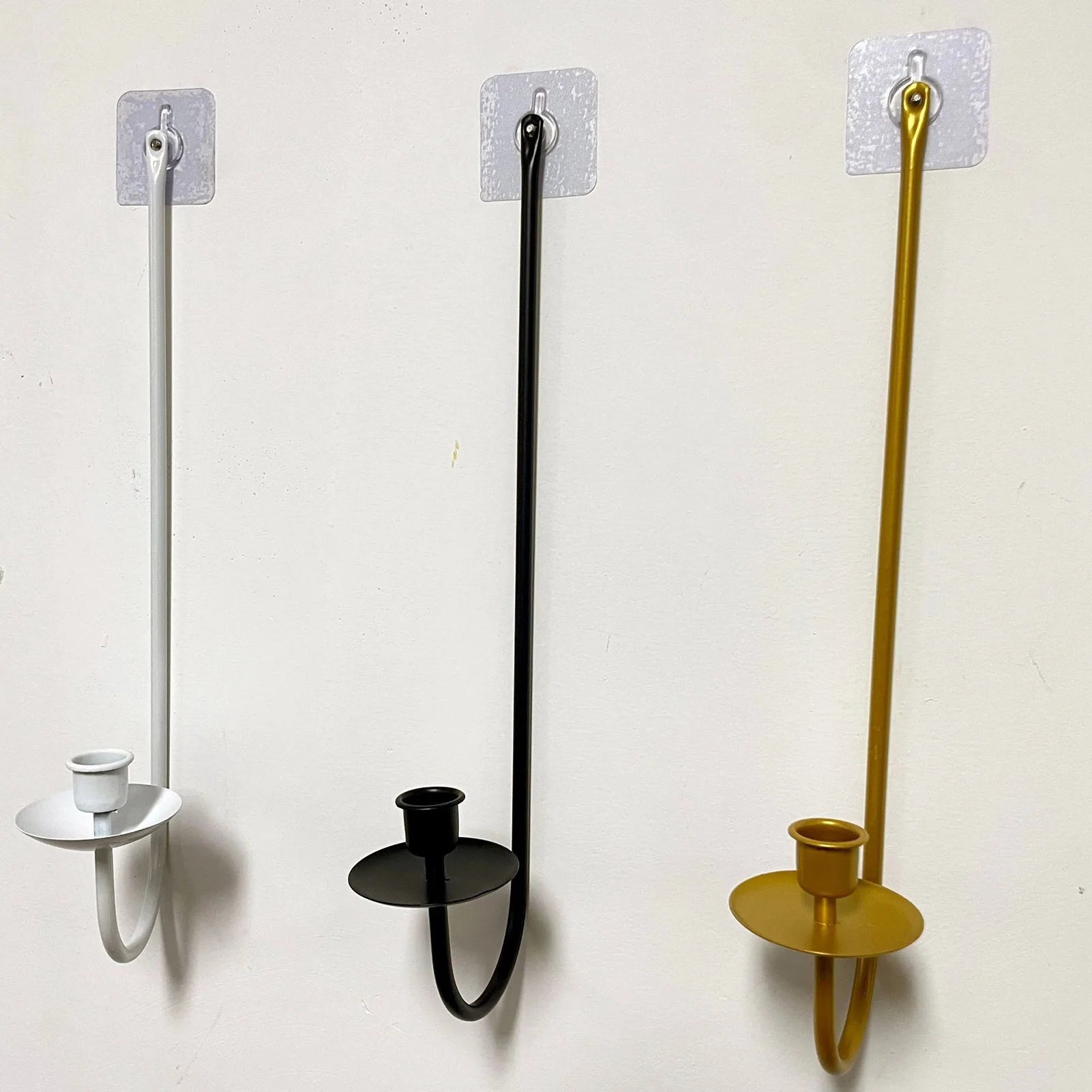 Party decor wall candle holders in white, gold and black.