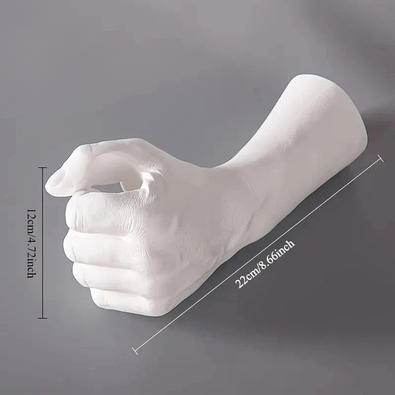 Contemporary novelty hand vase mounted on a gray wall.