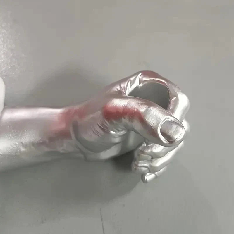 Creative resin hand holding glass tube flower vase.