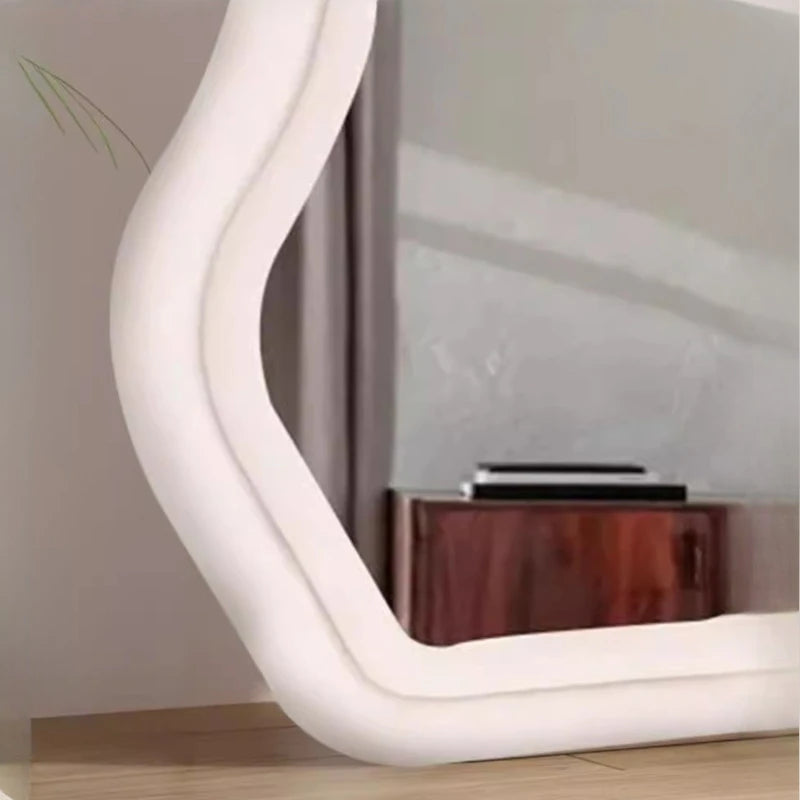 Light pink curvy wall mirror for minimalist aesthetic home.