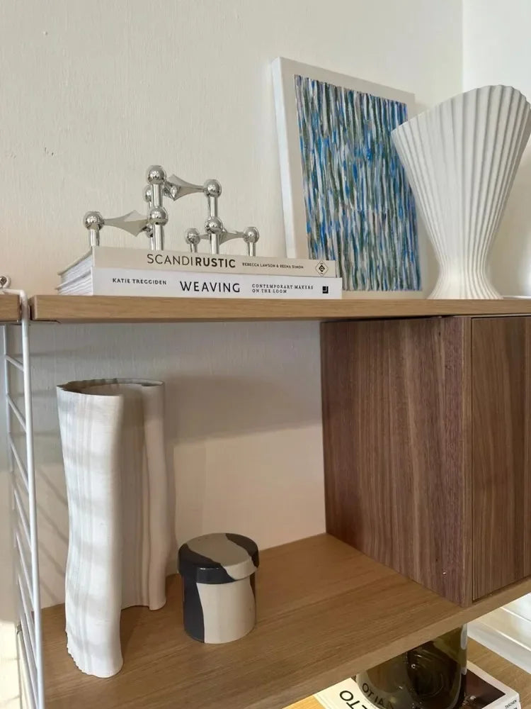 Silver candlestick with molecular structure design.