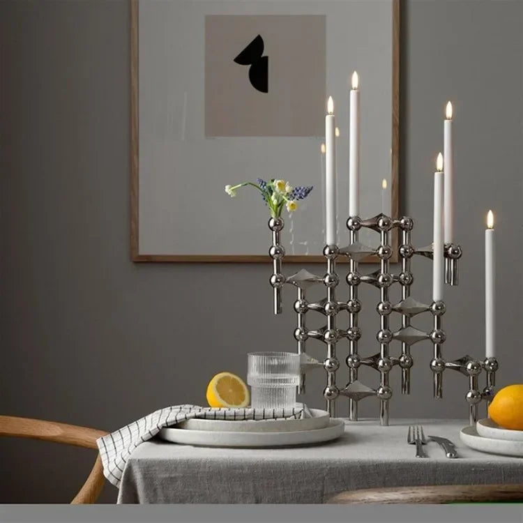 Modern chrome candle stand for minimalist home styling.
