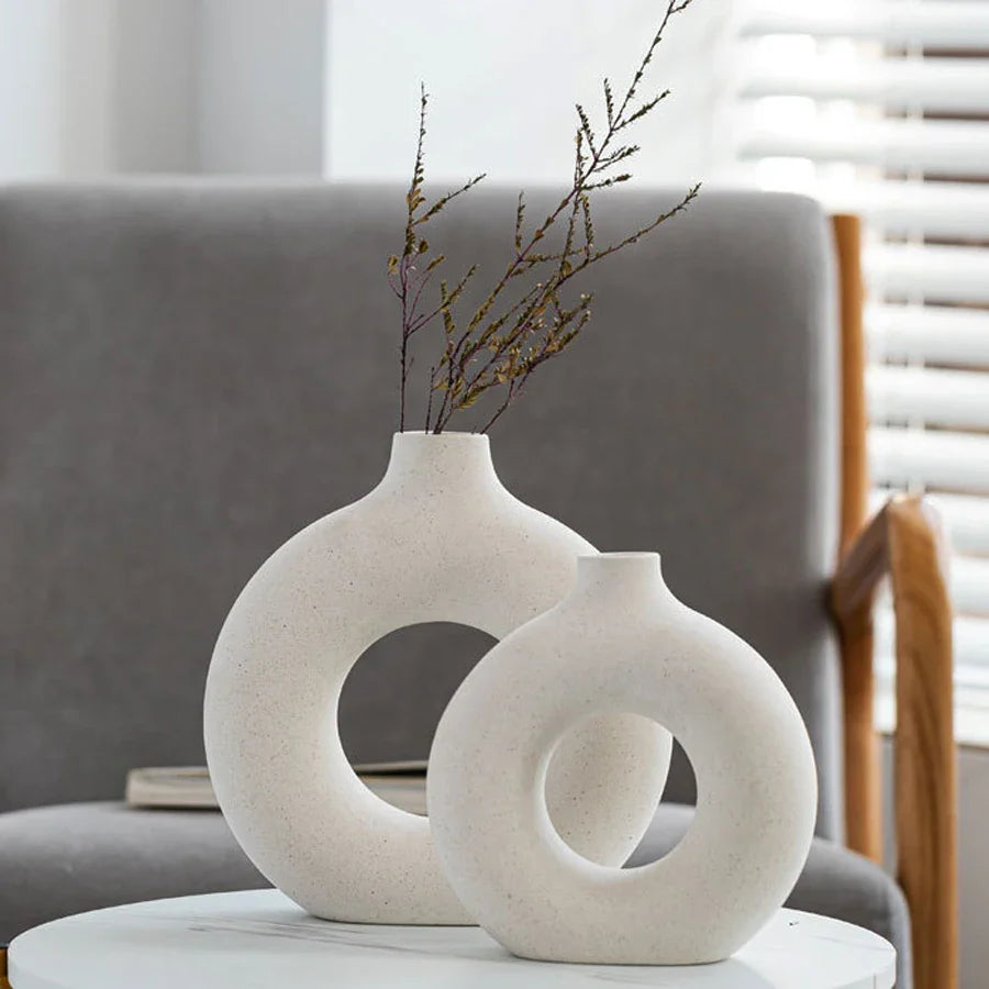 Nordic circular hollow ceramic vase with donut design.