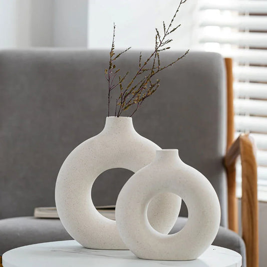 Nordic circular hollow ceramic vase with donut design.