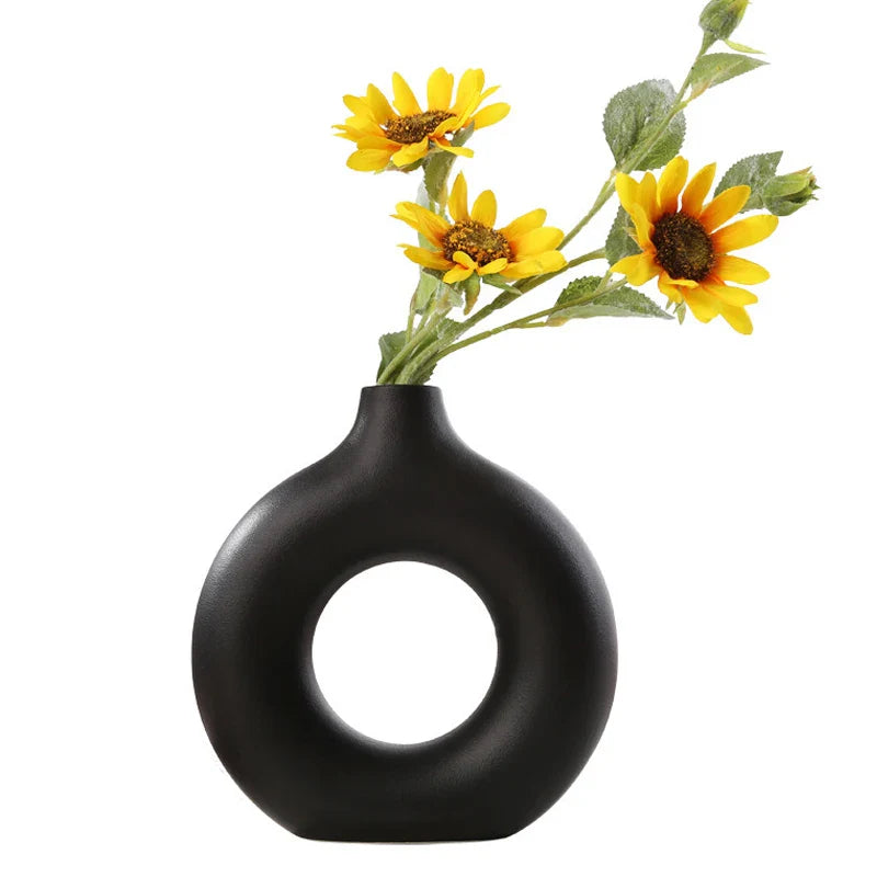 Modern donut-shaped ceramic vase for home decoration.