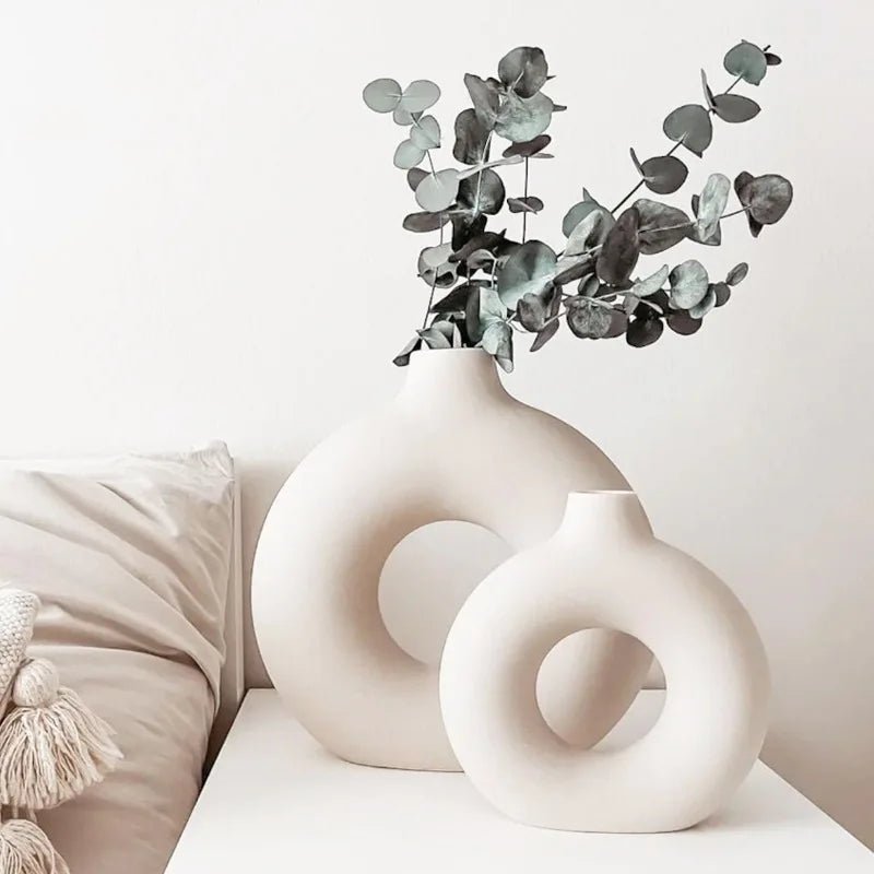 Round hollow ceramic vase for modern interior styling.