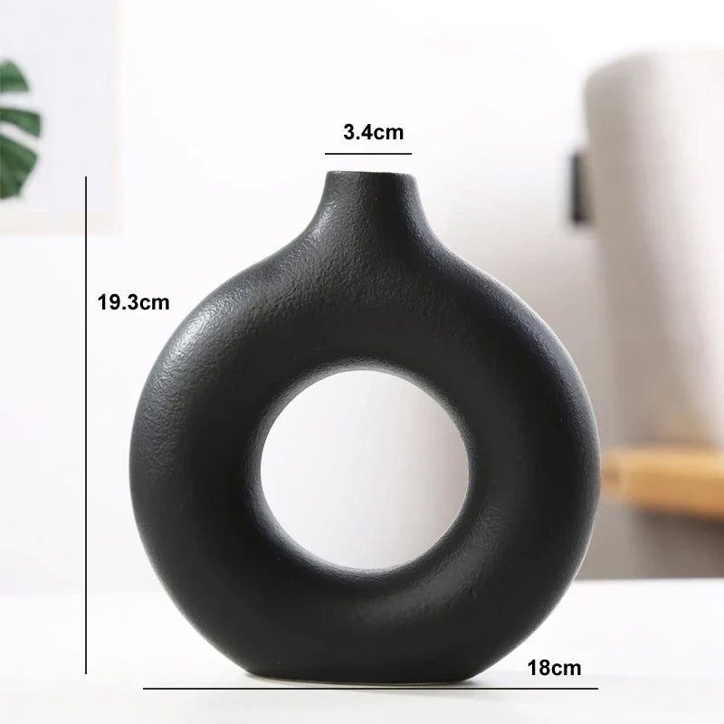 Neutral-toned ceramic donut vase for elegant room décor.