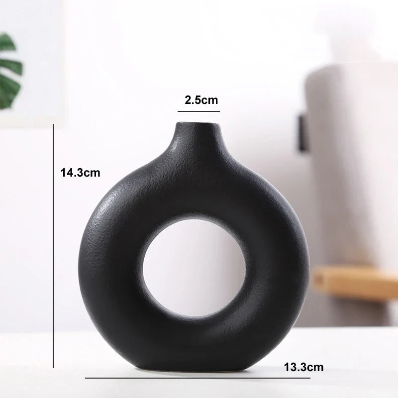 Minimalist round hollow ceramic vase for living room decoration.