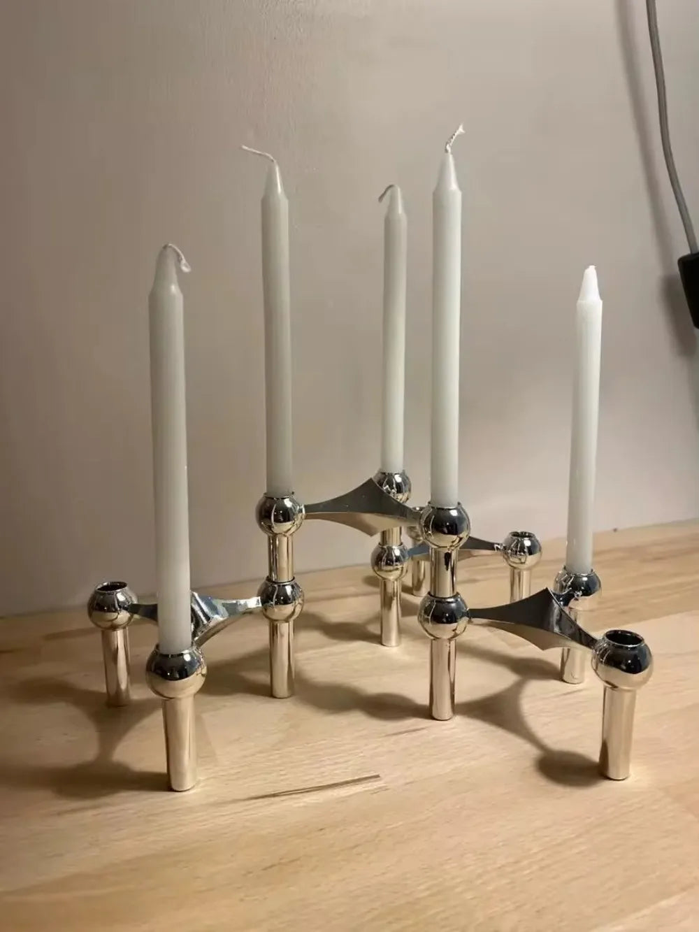 Scandinavian-style silver candle holder set for elegant interiors.