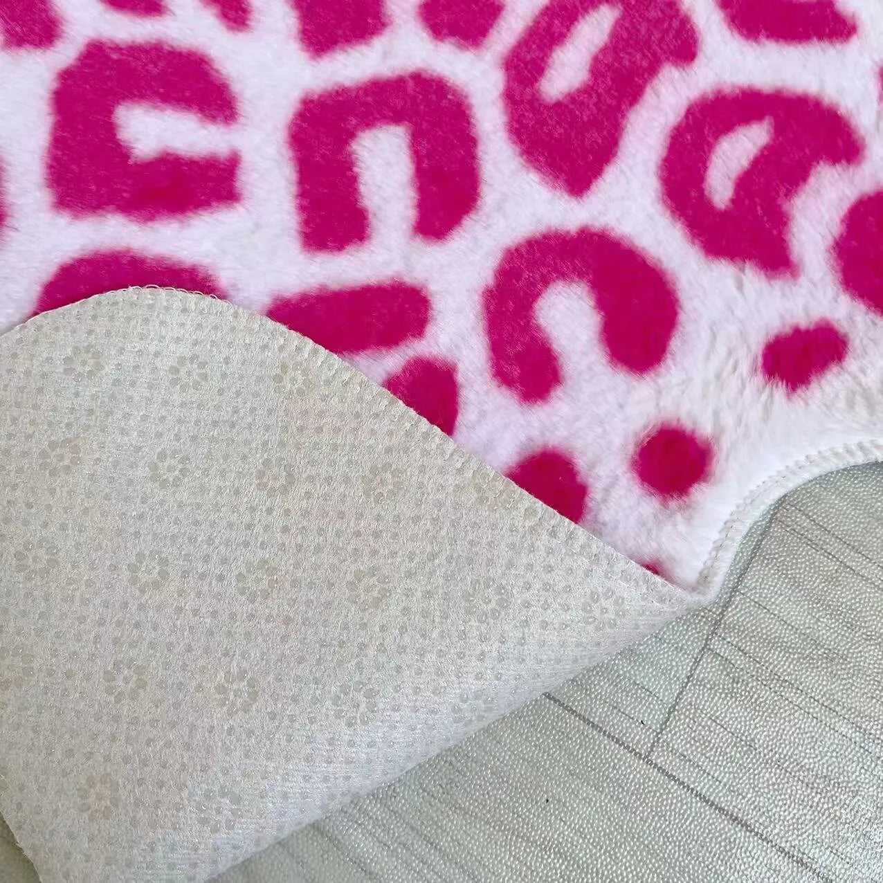 Nordic-style pink animal print floor rug for interiors.
